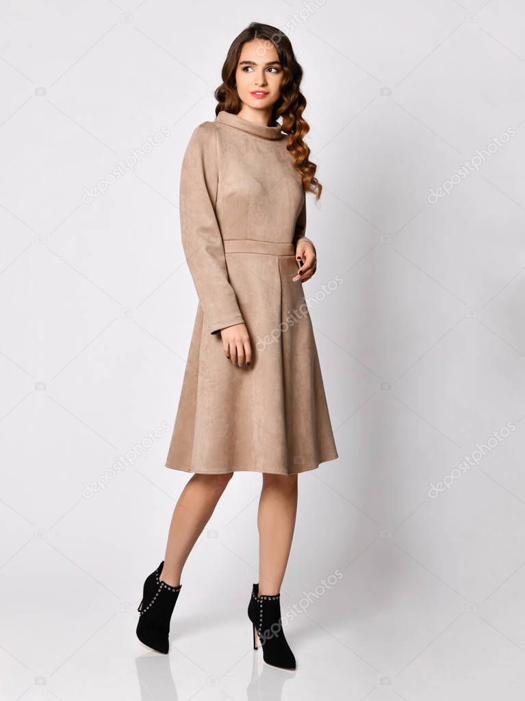 Young beautiful woman posing in new gray suede winter fashion dress 