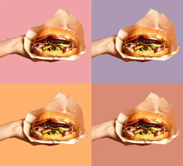 Kobieta ręce trzymać big cheese burger grilla kanapkę z marmuru wołowiny na fioletowy — Zdjęcie stockowe
