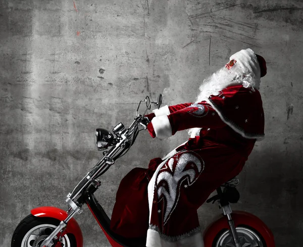 Santa Claus ride electric motorcycle bicycle scooter with bag full of presents and text copy space — Stock Photo, Image