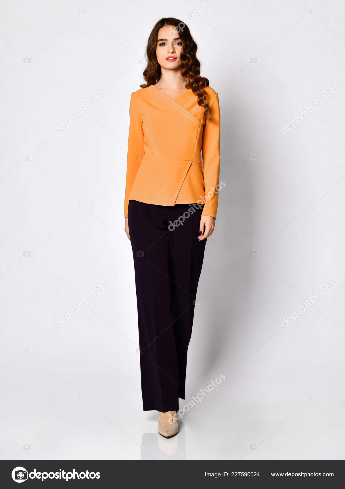 Young beautiful brunette woman posing in new casual yellow orange