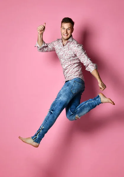 Happy winner man celebrating successful deal winning pointing hands fingers up over pink — Stock Photo, Image