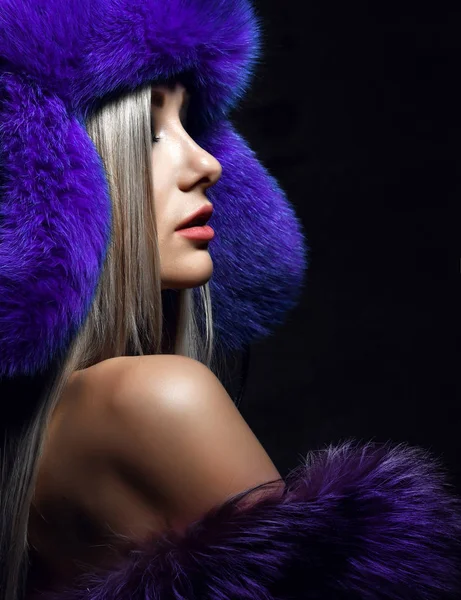 Portrait of young beautiful woman in blue purple fashion arctic fox winter fur ear flap hat — Stock Photo, Image