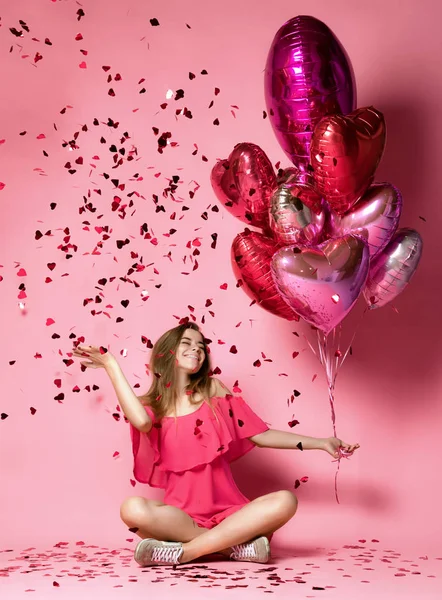 Valentine Beauty girl hold red and pink air balloons laughing on pink background celebrating Valentines Day — Stock Photo, Image