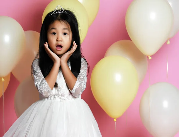 Surprised kid girl with balloons in princess dress with tiara — Stock Photo, Image