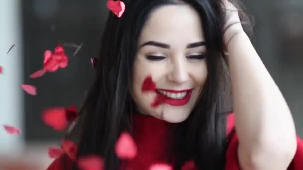 Young beautiful woman hapyy dancing with red hearts falling down on valentines day — Stock Video