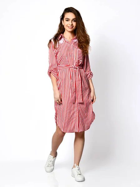 Young beautiful woman posing in new light pink red stripes fashion dress on high hills full body on a white — ストック写真