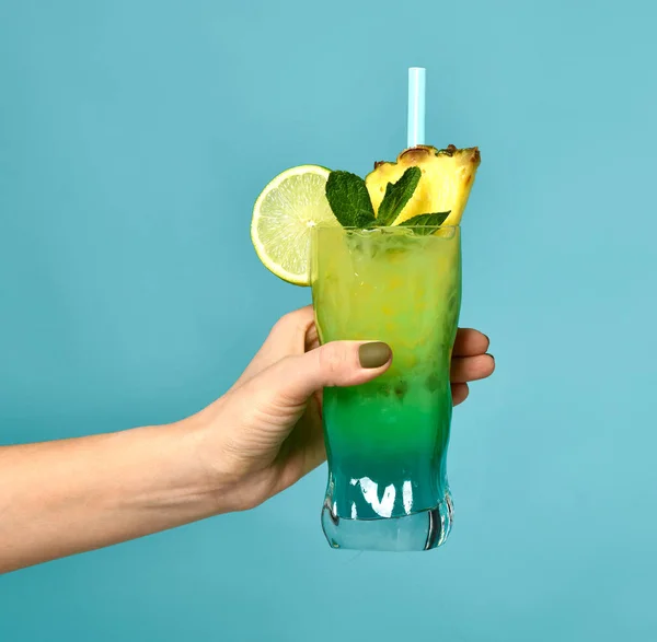 Summer blue and green tropical alcohol mojito cocktail drink with pineapple in woman hand — Stock Photo, Image