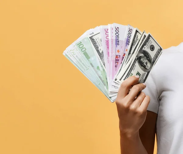 Kvinnlig hand visar ett fan av sedlar kontanter dollar och euro — Stockfoto
