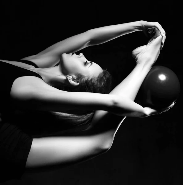 Young sporty woman doing gymnastics stretching fitness exercises workout with ball in sport club Royalty Free Stock Photos
