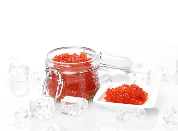 Salmon Keta red fish caviar in jar can and little plate with ice on table. Sea food — Stock Photo, Image