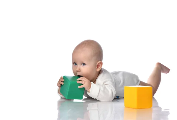 Infant child baby toddler sitting in diaper with green red educational brick toy playing — Stock Photo, Image