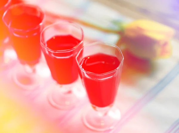Köstliches alkoholisches Preiselbeergetränk in Gläsern auf gelber Rose — Stockfoto
