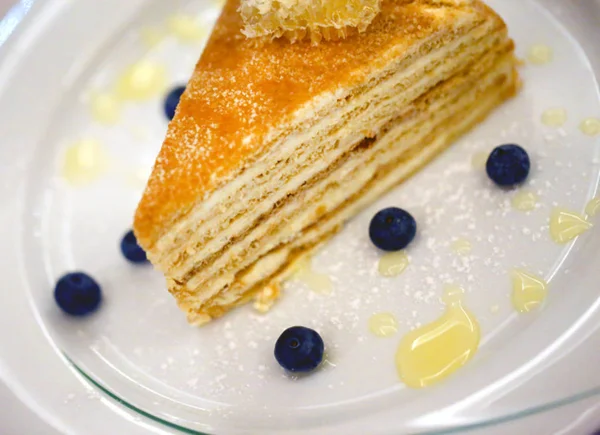 Delicious honey cake on a saucer photographed — Stock Photo, Image