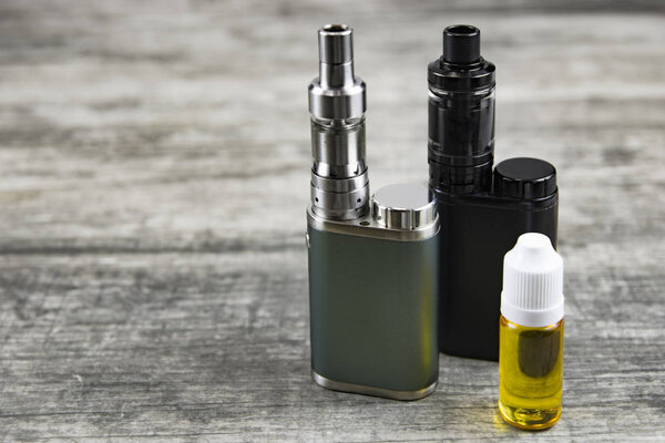 Electronic cigarette for vaping, technical devices.The liquid in the bottle. Current, drip.