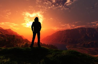 Bir adamın silueti peyzajın arka planına dayanır.
