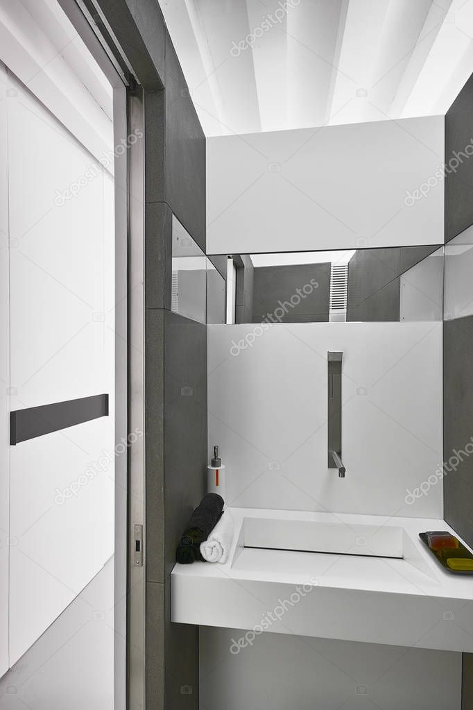 interiors shots of a modern bathroom with large tiles floor in foreground the bidet and toilette bowl in the bottom the glass shower box