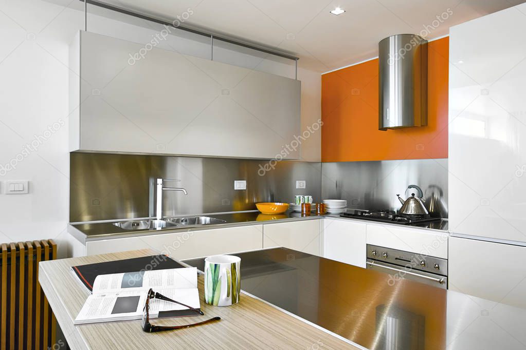interiors shots of a modern kitchen  with steel hood and kitchen island