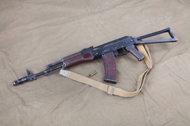 Kalashnikov AK 74 with ammunitions on canvas background clipart