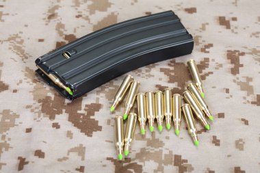 5.56 mm cartridges on US MARINES uniform background clipart