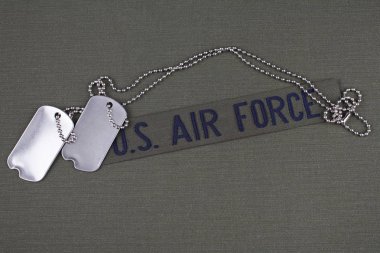 U.S. AIR FORCE Branch Tape with dog tags on olive green uniform background clipart