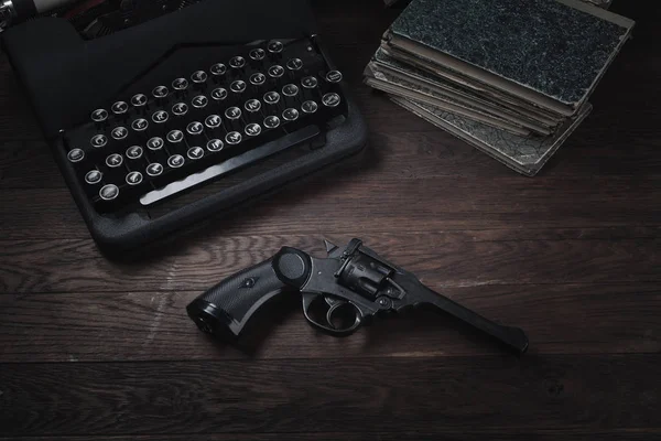 犯罪小说 旧复古老式打字机和左轮手枪在木桌上 — 图库照片
