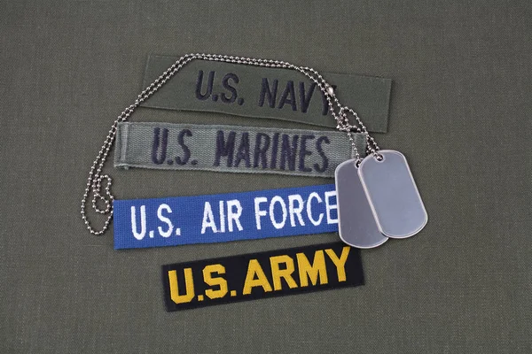 USA veteran concept with dog tags on olive green uniform background