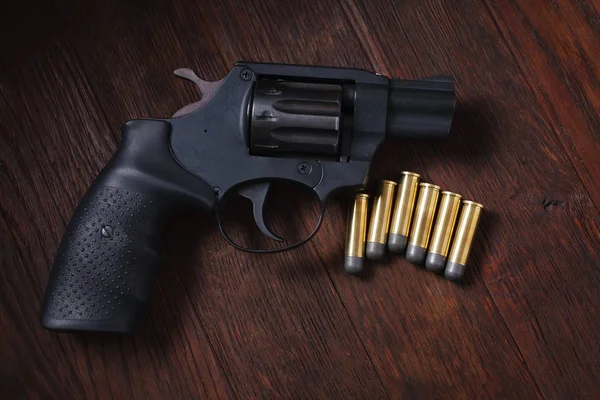 Illegal handgun on wooden table — Stock Photo, Image