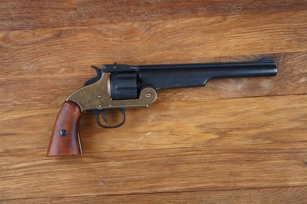 old west era .44 smith and wesson single action revolver isolated on wooden background