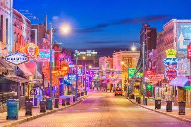 MEMPHIS, TENNESSEE - AUGUST 25, 2017: Blues Clubs on historic Beale Street at twilight  clipart