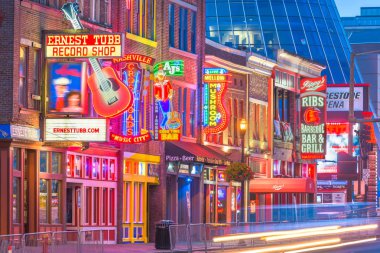 NASHVILLE, TENNESSEE - AUGUST 20, 2018: Honky-tonks on Lower Broadway. The district is famous for the numerous country music entertainment establishments.  clipart