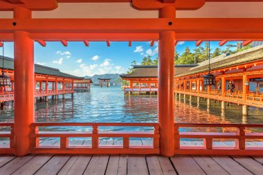 HIROSHIMA, JAPAN - DECEMBER 3, 2015: The open air halls of Itsukushima Shrine on Miyajima Island. The shrine is known for the famous floating torii gate. clipart