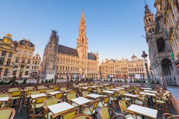 Grand Place, Brussels, Belgium with the Town Hall and cafe seating.
