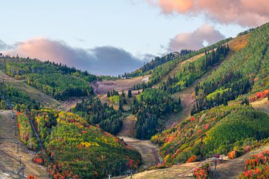 Park City, Utah, USA snowless ski slopes in autumn during the morning time. clipart