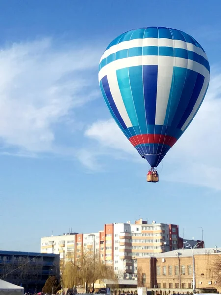 the balloon blast off in the city against the blue sky