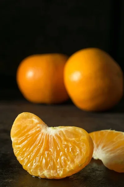 テキストのコピー スペースと暗い背景にオレンジ タンジェリンのジューシーなセグメントの — ストック写真
