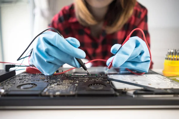 Engineer repairs laptop support fixing notebook computer
