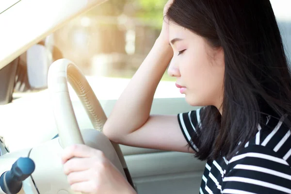 Stressed Asian woman driver sitting in car having headache stop after driving car in traffic jam.  Exhausted Japanese driver automobile transportation concept. Committing infringement fine punishable. — Stock Photo, Image