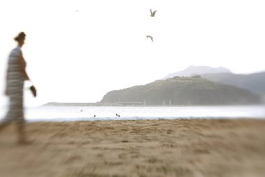 Blurred girl silhouette on the beac