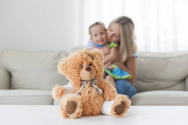 Teddy Bear Bandage Paw Mom Hugs Her Daughter Background — Stock Photo, Image