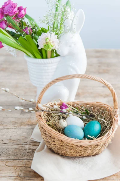Wicker Basket Easter Eggs Foreground Hare Vase Spring Flowers Background — Stok fotoğraf
