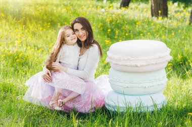 Anne ve küçük kızı Apple çiçeklenme baharda yürümek 