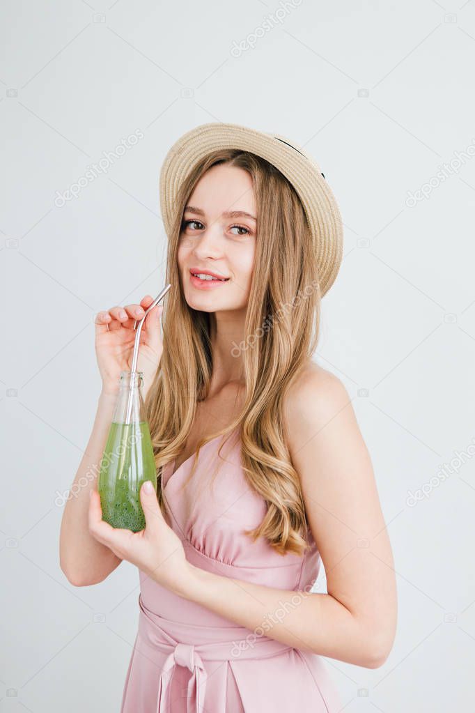 Girl drinks a healthy green drink with Basil seeds 
