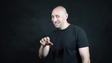 Siyah tişörtlü kel bir Avrupalı..