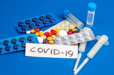 Covid-19, tıbbi aletler, şırınga ve renkli ilaçlar.
