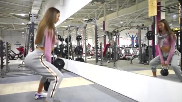 Mujer atlética sentadillas con una barra. — Vídeos de Stock