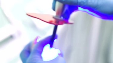 Kadın dişçi hasta dişlerini kontrol ediyor.