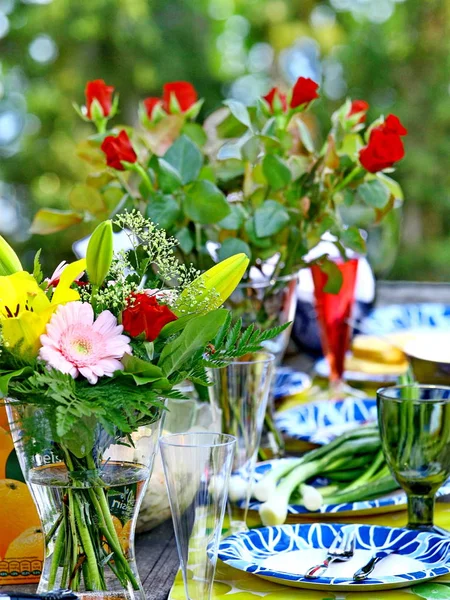 Outdoor event table and plate setting with flowers
