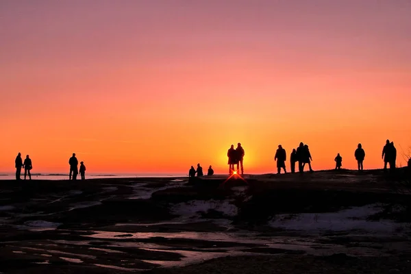 Temné siluety lidí na zimní slunce pozadí — Stock fotografie