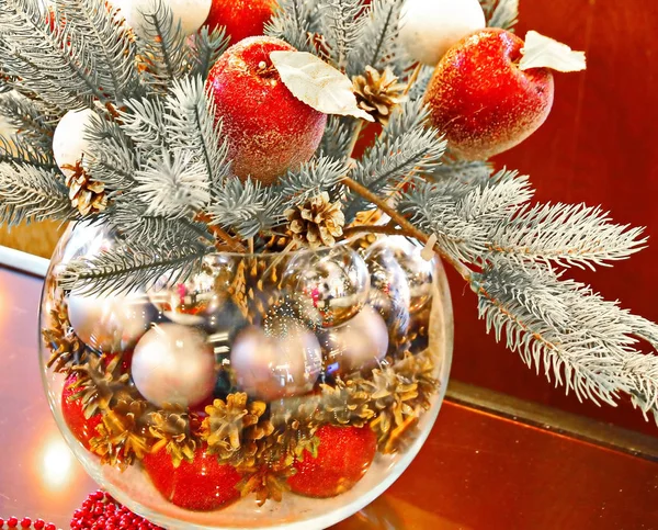 Christmas holidays composition with red apples, silver balls, andglass vase — Stock Photo, Image