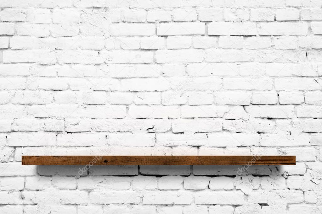 Wooden shelf over white brick wall background